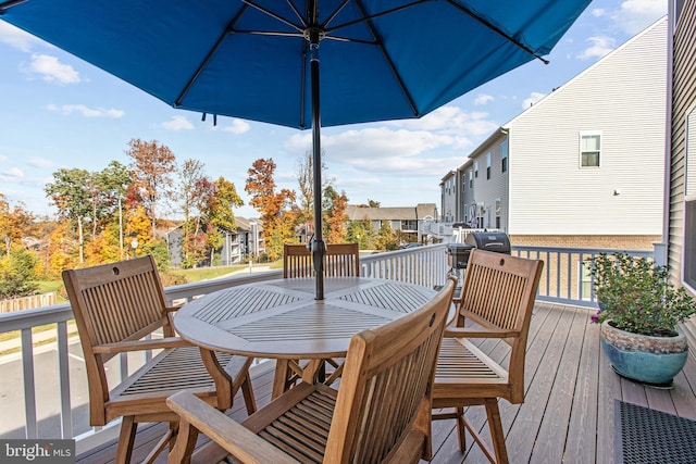 wooden terrace with a residential view and outdoor dining area