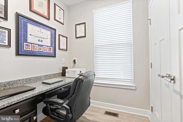 office featuring visible vents, light wood-style flooring, and baseboards