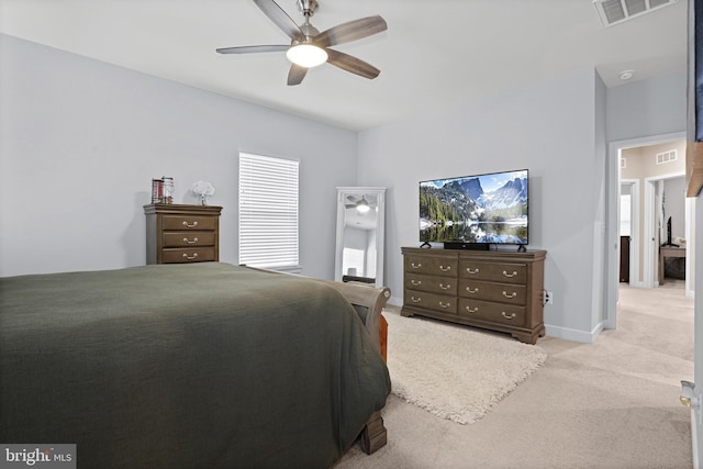 bedroom featuring ceiling fan, visible vents, baseboards, and light colored carpet