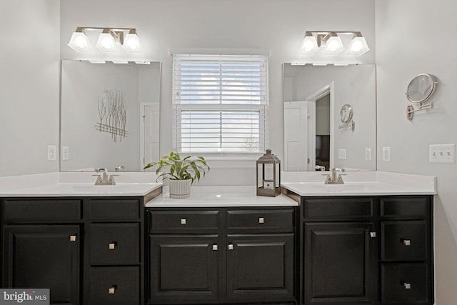 full bathroom with double vanity and a sink