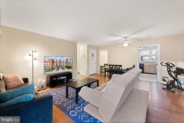 living room with ceiling fan and hardwood / wood-style floors