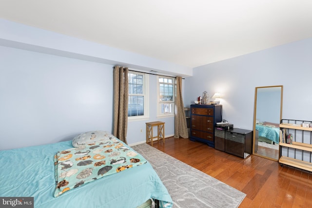 bedroom with hardwood / wood-style flooring