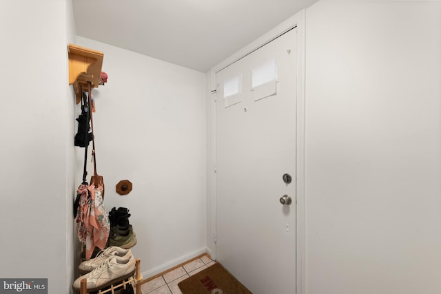 doorway with light tile patterned floors