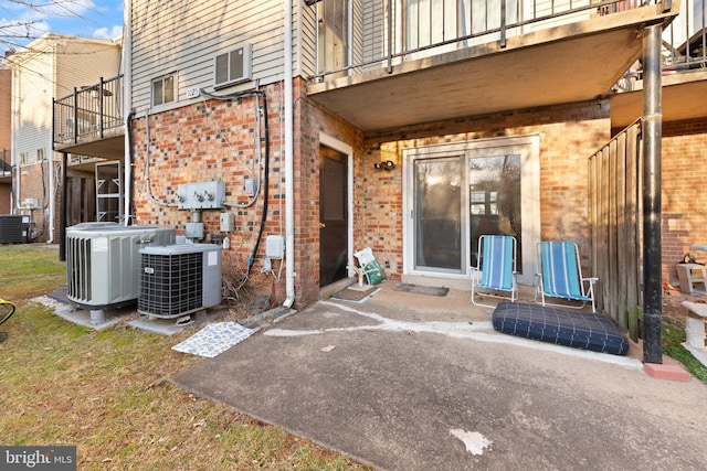 exterior space featuring cooling unit, a balcony, and a patio