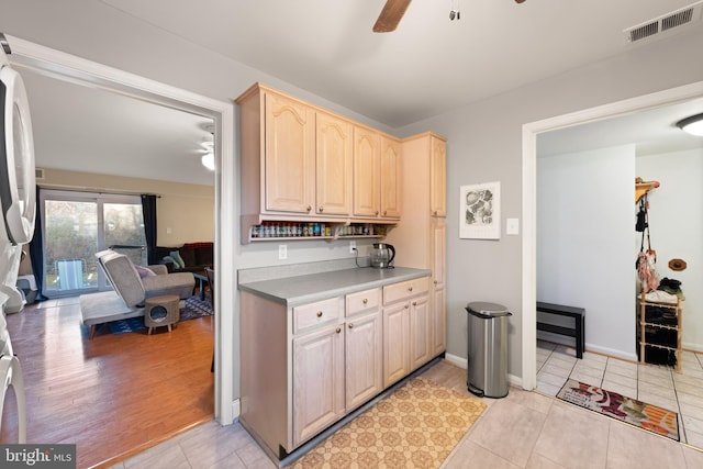 kitchen featuring ceiling fan, light brown cabinetry, and light tile patterned floors