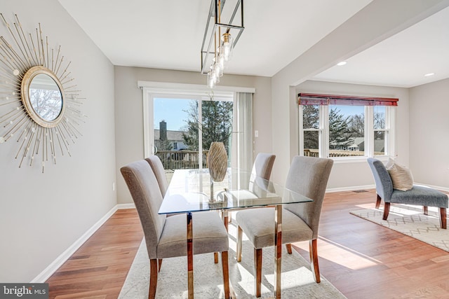 dining room featuring light wood finished floors, recessed lighting, and baseboards