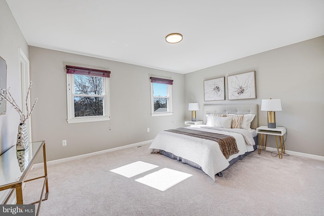 bedroom featuring baseboards and light colored carpet