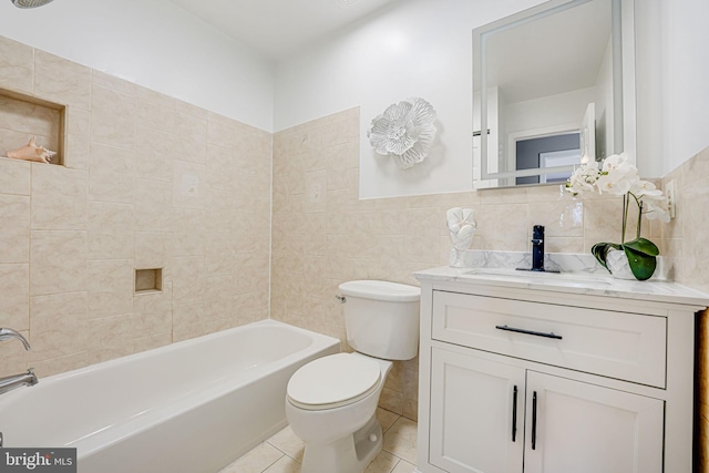 full bathroom with tile walls, shower / bathing tub combination, toilet, vanity, and tile patterned floors