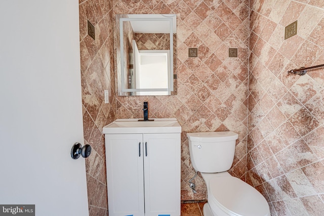 half bathroom featuring toilet and vanity