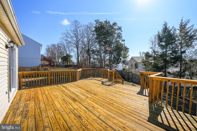 wooden deck featuring a fenced backyard