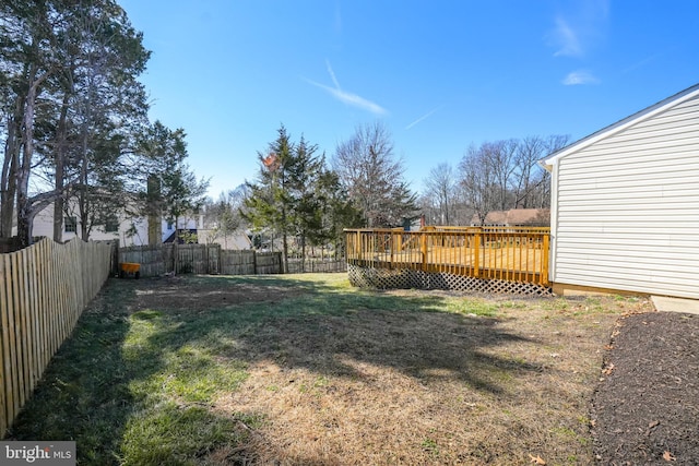 view of yard featuring a fenced backyard and a deck