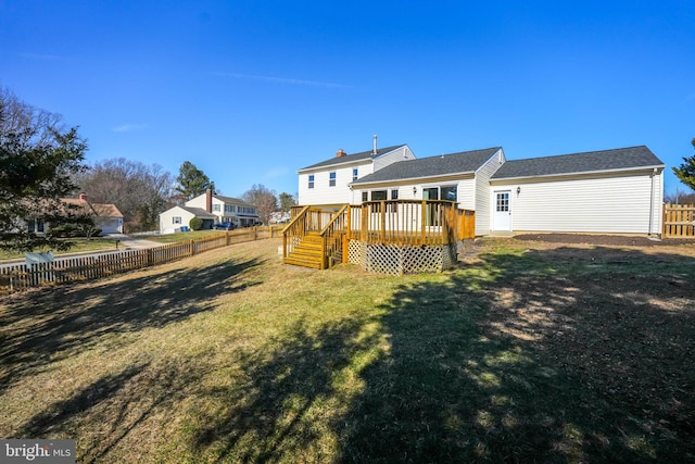 back of property featuring a fenced backyard, a lawn, and a wooden deck