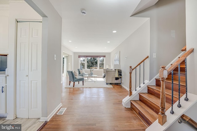 entrance foyer with light wood-type flooring, visible vents, recessed lighting, and stairs