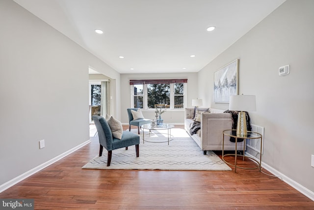 living room with recessed lighting, baseboards, and wood finished floors