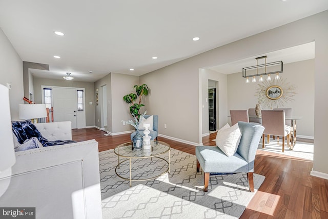 living room featuring baseboards, wood finished floors, and recessed lighting