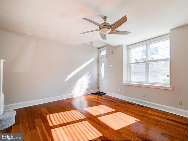 unfurnished living room with hardwood / wood-style flooring and ceiling fan