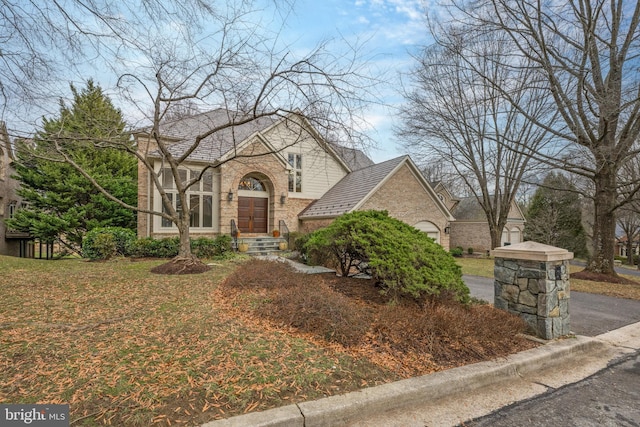 tudor-style house with brick siding