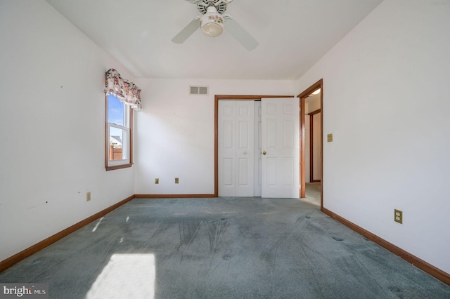 unfurnished bedroom featuring ceiling fan, a closet, and carpet