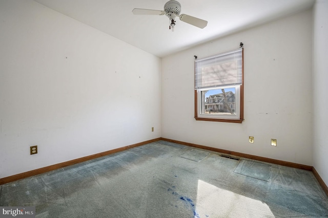 carpeted empty room featuring ceiling fan