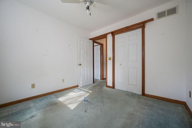 unfurnished bedroom with carpet floors, ceiling fan, and a closet