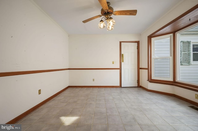 empty room featuring crown molding and ceiling fan