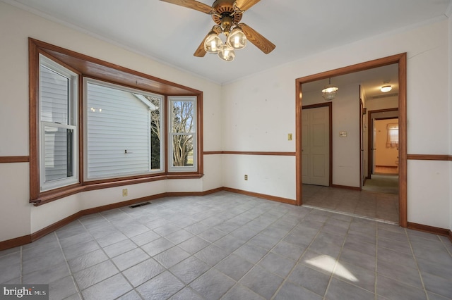 spare room featuring light tile patterned floors and ceiling fan