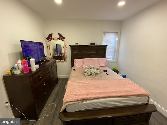 bedroom with dark wood-type flooring