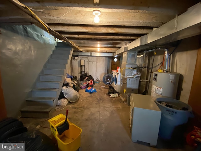 basement with gas water heater, heating unit, and washer and clothes dryer