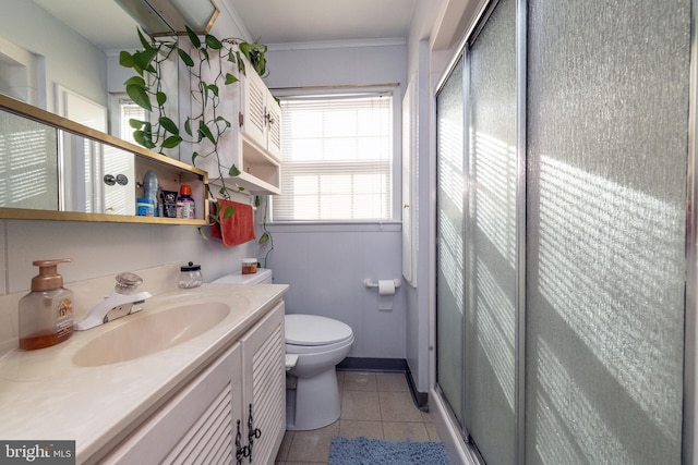 bathroom featuring tile patterned flooring, vanity, an enclosed shower, toilet, and crown molding