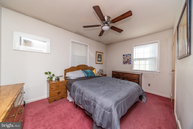 bedroom with ceiling fan and dark carpet