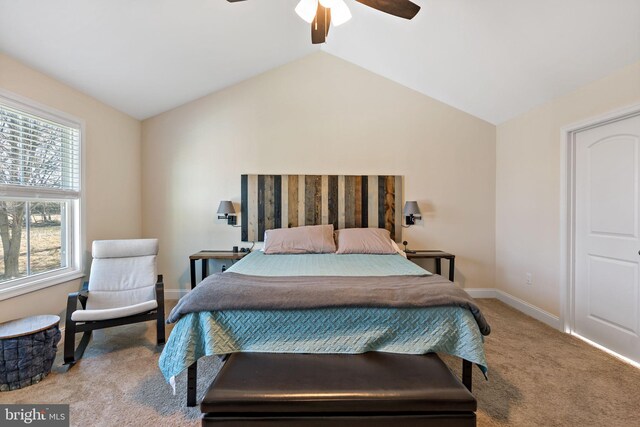 carpeted bedroom featuring vaulted ceiling and ceiling fan