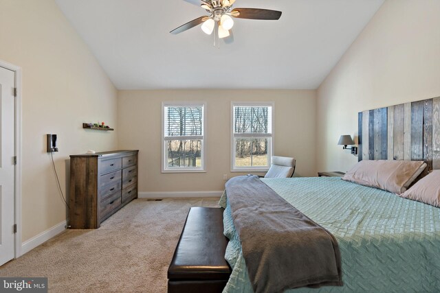 bedroom with lofted ceiling, light carpet, and ceiling fan