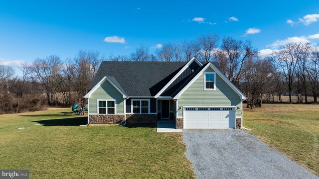 view of front of property featuring a garage and a front lawn