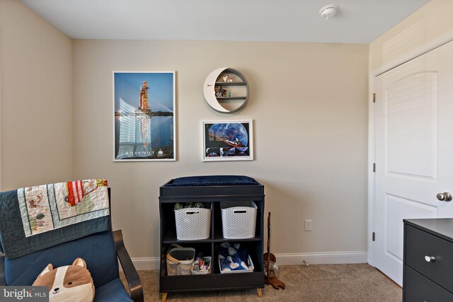 living area featuring carpet