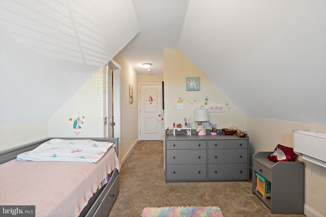 bedroom with lofted ceiling and carpet floors