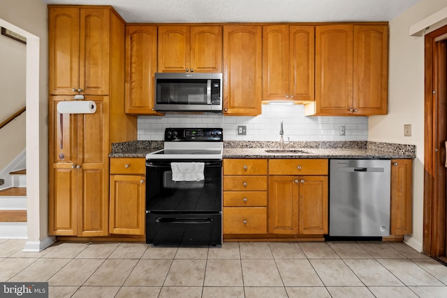 kitchen featuring stainless steel appliances, light tile patterned flooring, sink, and decorative backsplash