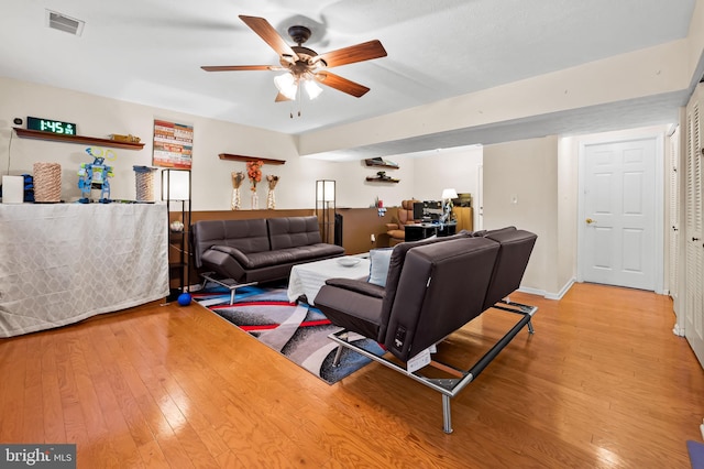 living room with ceiling fan and light wood-type flooring