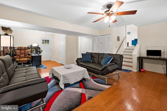 living room with ceiling fan and light hardwood / wood-style flooring