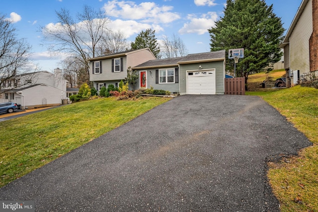 split level home with a garage and a front yard