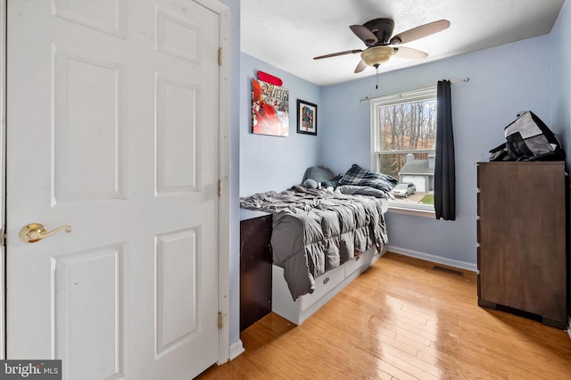 bedroom with ceiling fan and light hardwood / wood-style floors