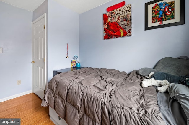 bedroom with hardwood / wood-style flooring