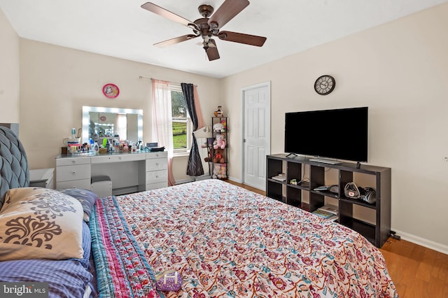 bedroom with hardwood / wood-style flooring and ceiling fan