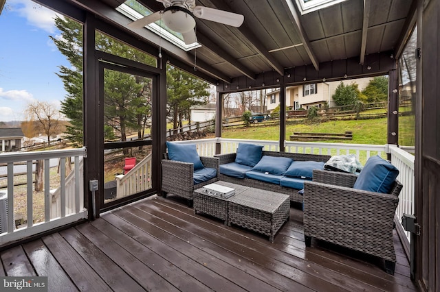 sunroom / solarium featuring vaulted ceiling and ceiling fan