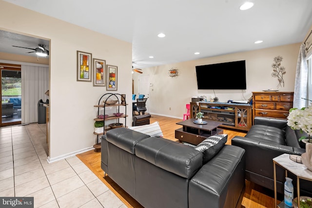 tiled living room with ceiling fan