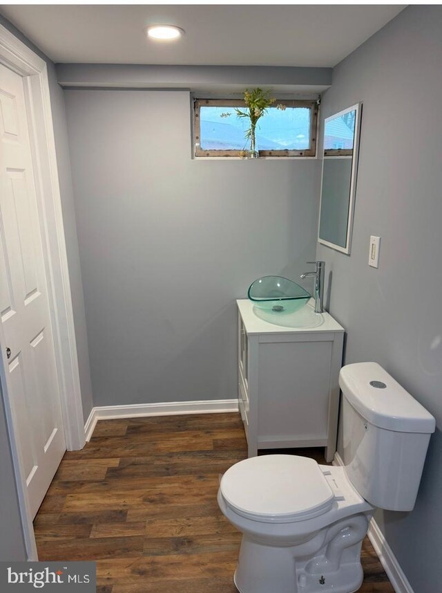 bathroom featuring hardwood / wood-style flooring, vanity, and toilet