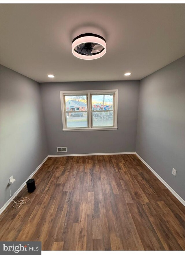 spare room featuring dark hardwood / wood-style flooring