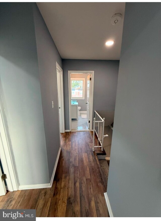 corridor with dark hardwood / wood-style floors