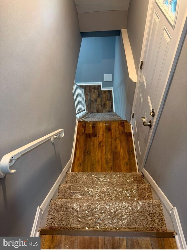 stairway featuring hardwood / wood-style floors