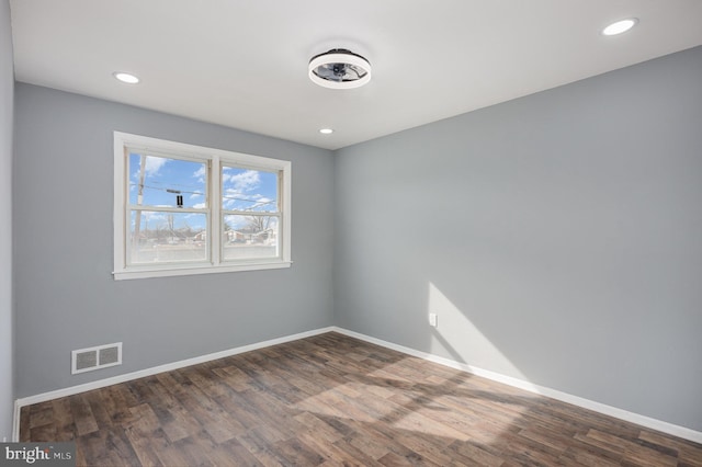 unfurnished room featuring dark wood-type flooring