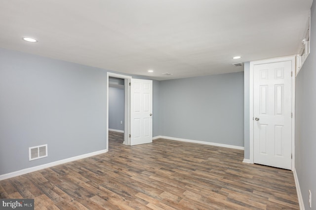 basement featuring dark hardwood / wood-style flooring